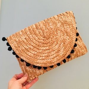 Straw clutch with black Pom poms
